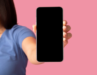 Woman showing blank smartphone screen for mockup