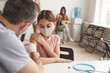 © Seventyfour - Portrait of unrecognizable doctor vaccinating cute little girl in medical clinic, copy space