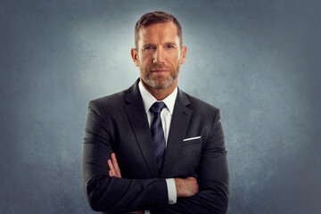 Poster - Portrait of senior lawyer standing with arms crossed at isolated background