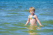 Beautiful little girl playing in the sea