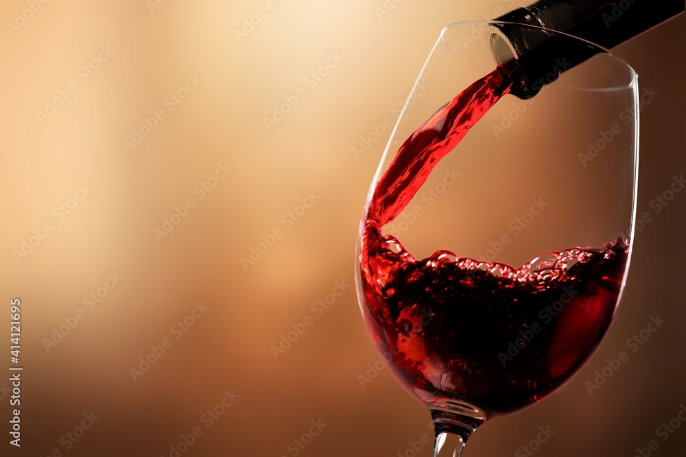 Red wine pouring from the bottle in glass - obrazy, fototapety, plakaty 
