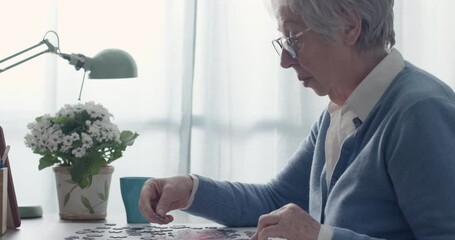 Wall Mural - Elderly woman playing puzzle at home