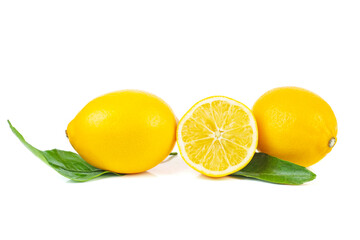 Wall Mural - Two whole and half lemons with leaves isolated on a white background