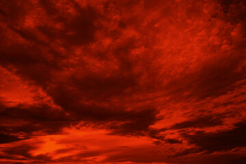 Wall Mural - Abstract dark red background. Dramatic red sky. Red sunset with clouds. Fantastic sunset background with copy space for design. Halloween, armageddon, apocalypse, end of the world concept.