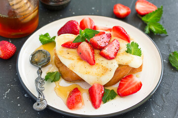 Poster - toast with grilled mozzarella, fresh strawberries and honey. Useful zavstrak.