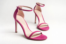 Woman's Pink High Heels Shoes With Ankle Strap On A White Background.