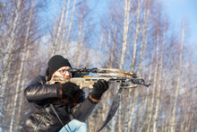 A Man Of European Appearance In The Winter Forest Shoots From A Sports Crossbow
