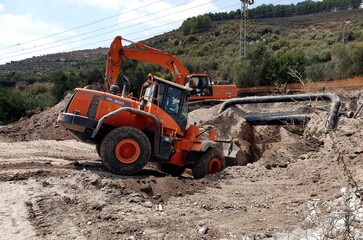 bulldozer at work, excavator on a construction site , earthwork , excavation , construction site 