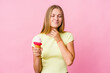 © Asier - Young russian woman eating an ice cream isolated suffers pain in throat due a virus or infection.
