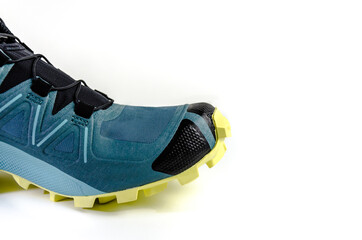 New isolated blue sneaker with yellow sole on white background. Shoe for mountain, trekking