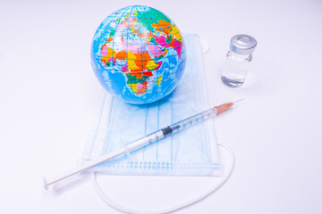 Medical drug vaccine syringe needle hypodermic injection treatment on map world ,Medical concept tourism travel care diseases Healthy .Covid 19, Flue shot. selective focus