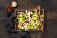 Mix Fresh Leaves Of Arugula, Lettuce, Spinach, Beets For Salad In Wooden Box On Wooden Rustic Background. Selective Focus.