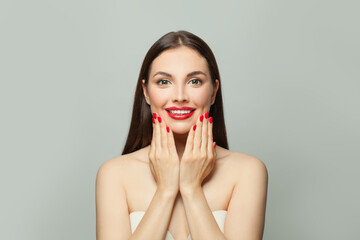 Wall Mural - Nice brunette woman showing her hands with red manicured nails. Body care and manicure concept