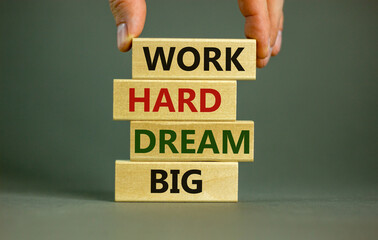 Work hard dream big symbol. Concept words 'Work hard dream big' on wooden blocks on a beautiful grey background. Businessman hand. Business, motivational and work hard dream big concept.