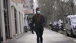 © Marco - Black man wearing covid face mask walking outside in city downtown