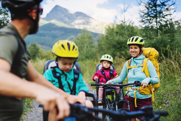Wall Mural - family with small children cycling outdoors in summer nature, tatra mountains slovakia.