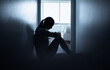 © kieferpix - Sad lonely woman sitting on the floor at home in a dark room. People problems, and mental health concept.