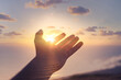 © kieferpix - Hand reaching out to sky, touching warm sunshine finger tips.