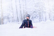 © Nastya - little girl sitting on the snow in the winter forest