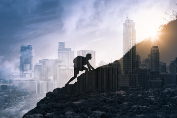 Wall Mural - Young man climbing up a mountain overlooking city fighting through obstacles and challenges. Determination, and life goals concept. 