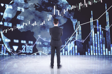 Wall Mural - Businessman analyses trading market changes looking at digital screen with world map and financial graphs. Double exposure