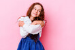 Little caucasian girl isolated on pink background hugs, smiling carefree and happy.
