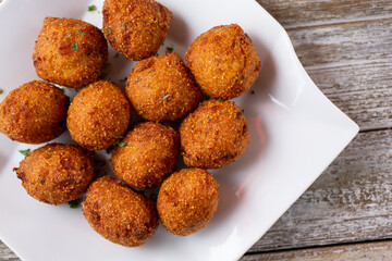 Wall Mural - A top down view of a plate of deep fried hush puppies.