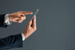 © Aliaksandr Marko - Side view of a man's hand presses a finger on a smartphone. Mock up for your design, copy space.