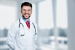 © BillionPhotos.com - Young man doctor holding stethoscope on background