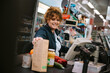 © Jacob Lund - Woman working in modern supermarket