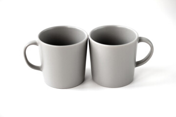 two grey cups in the studio on a white background