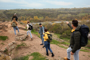 Poster - Group of hikers with backpacks climbing up mountains