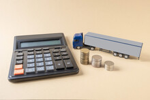 Calculator, Mock-up Of Tractor-trailer, Coins Placed On Light Background. Concept. Tariffs, Calculation, Freight Transport Costs By Truck.