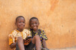 © Confidence - two african kids smiling while using a phone