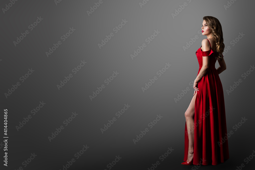 Fashion Woman in Long Red Dress. Model Showing Leg in Evening Silk Slit Gown.  Side Profile View. Black Background with Copy Space Stock Photo | Adobe  Stock