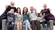 © ASDF - happy family sitting on a large comfortable sofa.