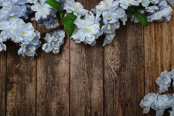 Sticker - Top view Blooming Flowers frame with copy space on wooden background