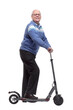 © ASDF - side view. happy senior man with electric scooter