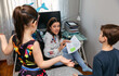 © David Pereiras - Angry mother scolding her children who interrupt her while telecommuting at home