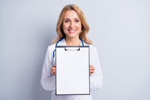 Photo Of Mature Charming Smiling Doctor Woman Hold Showing Organizer Check List Isolated On Grey Color Background
