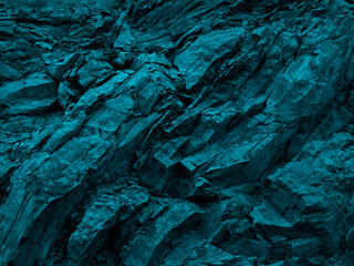 Wall Mural - blue green rock background. dark turquoise toned mountain surface. close-up. 3d effect. modern color