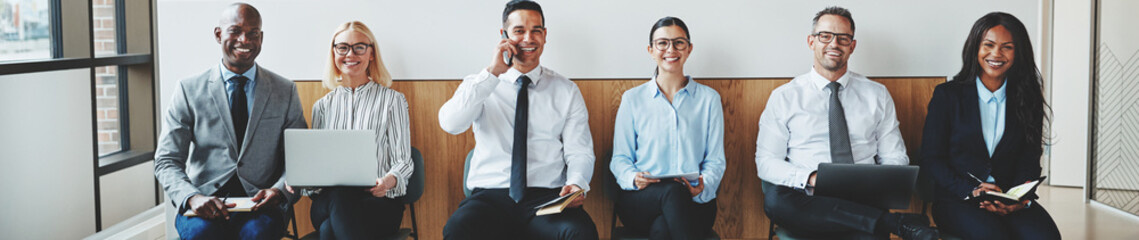 Smiling businesspeople sitting together in an office reception