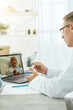 © Kostiantyn - Doctor talking with patient through video call in clinic