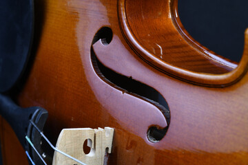 Sticker - Closeup shot of a wooden violin detail on a black background