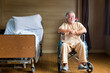 © Thirawatana - A sick person on a wheelchair in ward. Senior man in wheelchair with doctor in hospital.