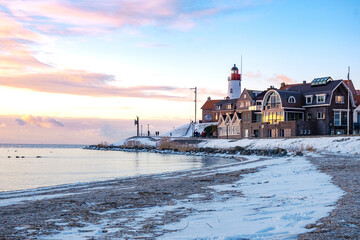 Wall Mural - Urk Netherlands lighthouse during winter with snow covered coastline, Urk view at the lighthouse snowy landscape winter weather in Holland. Europe