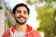 © Mego-studio - Close-up of young man smiling outdoors.