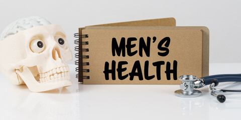 On the table lies a skull, a stethoscope and a notebook with the inscription - MEN S HEALTH