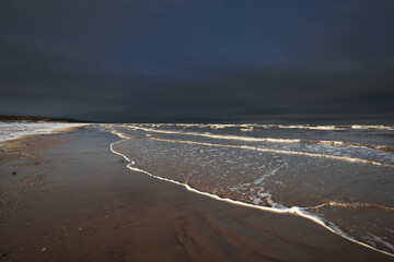 Wall Mural - Frozen Baltic sea shore at sunset, snow texture close-up. Dramatic sky. Picturesque winter scenery. Seasons, nature, ecology, environment, climate change, global warming. Panorama, copy space