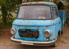 An Old Rotten Blue Car With A Body.